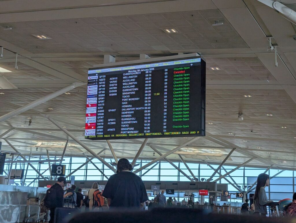 Flight board at Brisbane International Airport showing departing flights.